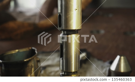 Factory workers assembling industrial shock absorber. Stock clip Factory workers assembling industrial shock absorber. Stock clip 135460363