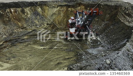 Excavator loading dump truck in quarry. Stock clip 135460369