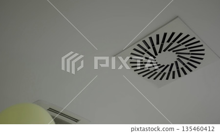 Balloons floating near air conditioning ceiling vents. Creative 135460412