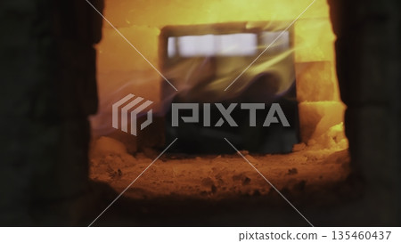 Hot metal glowing inside brick furnace. Stock clip 135460437