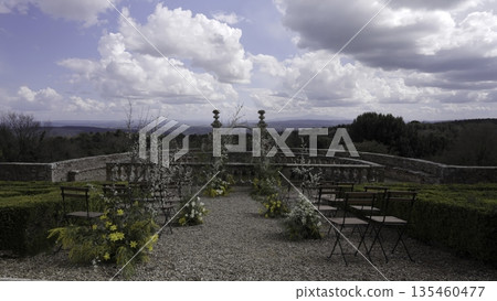 Wedding ceremony location overlooking tuscan hills with floral decorations. Action 135460477