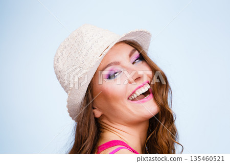 Woman in summer straw hat on head smiling Woman in summer straw hat on head smiling 135460521