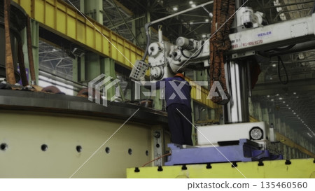 Factory worker operating machinery for metalworking. Stock clip Factory worker operating machinery for metalworking. Stock clip 135460560
