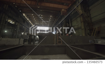 Workers welding metal in large industrial factory. Stock clip Workers welding metal in large industrial factory. Stock clip 135460573