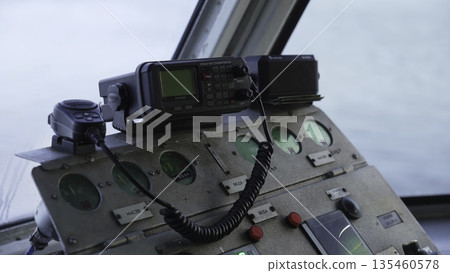 Captain using ship radio controls on bridge. Clip 135460578