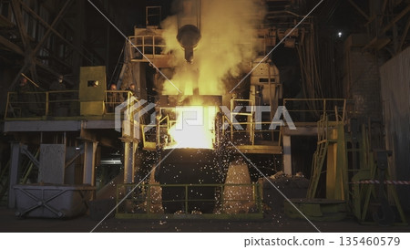 Molten metal pouring into a container in steel mill. Stock clip 135460579