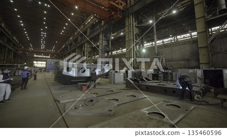 Shipbuilders welding metal parts in a shipyard. Stock clip Shipbuilders welding metal parts in a shipyard. Stock clip 135460596