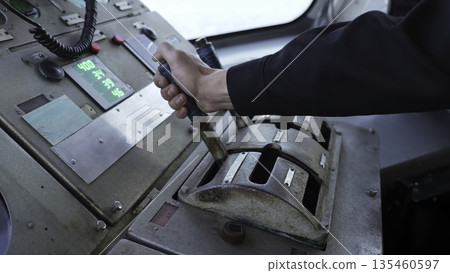 Captain operating levers on ship's bridge control panel. Clip 135460597
