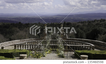 Wedding arch overlooking tuscan landscape at castello di velona resort. Action Wedding arch overlooking tuscan landscape at castello di velona resort. Action 135460598