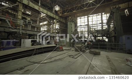 Industrial worker welding large metal component in factory. Stock clip 135460620