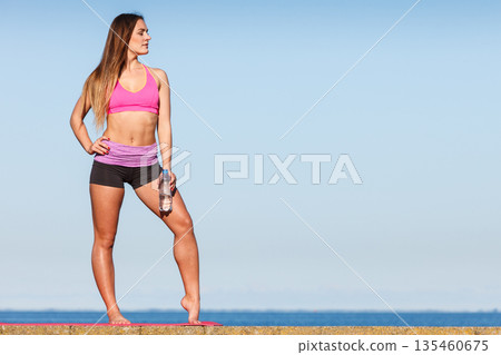 Woman drinking water after sport gym outdoor 135460675