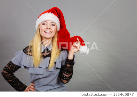Happy woman wearing Santa Claus helper hat Happy woman wearing Santa Claus helper hat 135460877