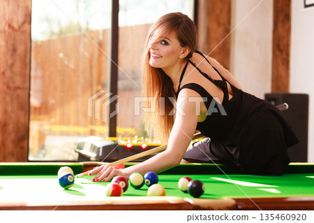 Young woman having fun with billiard. Young woman having fun with billiard. 135460920