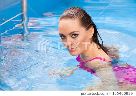 woman enjoying the water in swimming pool woman enjoying the water in swimming pool 135460939