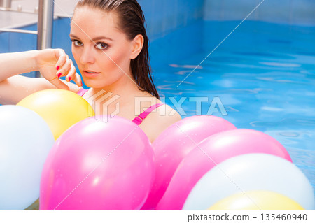 Girl relaxing in swimming pool 135460940