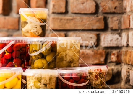Jars with pickled vegetables in cellar 135460946