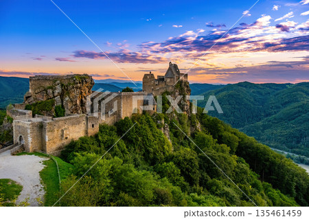 Aggstein Castle towers over the Wachau Valley Austria, breathtaking views of the surrounding landscape. The ancient structure is a remarkable example of medieval architecture amidst lush greenery. Aggstein Castle towers over the Wachau Valley Austria, breathtaking views of the surrounding landscape. The ancient structure is a remarkable example of medieval architecture amidst lush greenery. 135461459