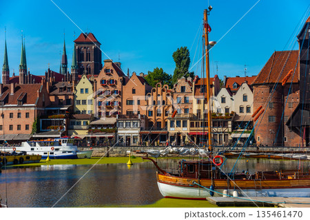 Scenic view of a marina on a sunny day, featuring a variety of yachts docked along the pier in Gdansk, Poland. Picturesque waterfront scene. Scenic view of a marina on a sunny day, featuring a variety of yachts docked along the pier in Gdansk, Poland. Picturesque waterfront scene. 135461470