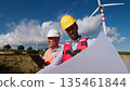 Engineers Cooperating During Work under wind turbine construction  135461844