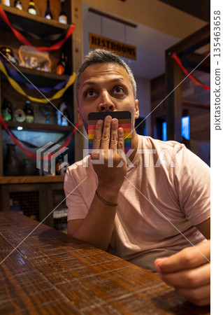 A man is playing a game with a deck of cards A man is playing a game with a deck of cards 135463658