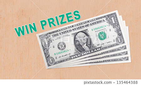 A stack of US one-dollar bills on a light wooden surface with the text "WIN PRIZES" in green. Concept of cash rewards, lottery winnings, and promotional contest prizes 135464388