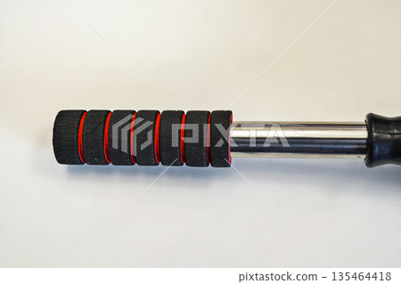 A close up view of a professional gray microfiber car duster featuring an ergonomic black and red foam handle, perfect for vehicle detailing, dust removal, and automotive maintenance A close up view of a professional gray microfiber car duster featuring an ergonomic black and red foam handle, perfect for vehicle detailing, dust removal, and automotive maintenance 135464418