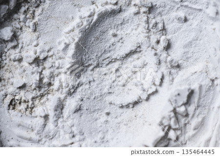 High-resolution macro shot of white powder texture with uneven surface, clumps, and circular patterns. Perfect for abstract backgrounds or representing flour, chalk, or cosmetics High-resolution macro shot of white powder texture with uneven surface, clumps, and circular patterns. Perfect for abstract backgrounds or representing flour, chalk, or cosmetics 135464445