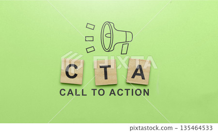 Flat lay composition of wooden blocks spelling CTA with call to action text and a megaphone icon on a green background. Business and marketing concept for driving sales 135464533