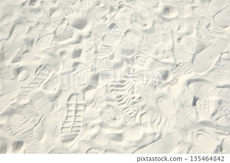 Footprints on the sand of a remote island beach 135464842