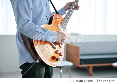 彈吉他的一個人的手 135465326