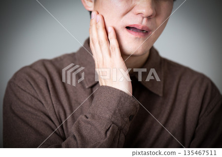 Middle-aged man suffering from toothache 135467511