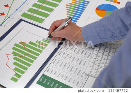 A person arranging and checking presentation materials A person arranging and checking presentation materials 135467732