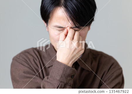 Middle-aged man suffering from tired eyes and blurred vision Middle-aged man suffering from tired eyes and blurred vision 135467922