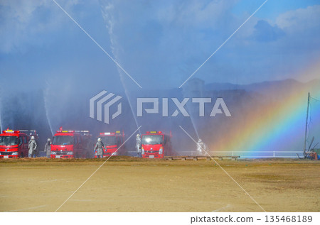 Water spraying demonstration and beautiful rainbow at the New Year's fire brigade ceremony 135468189