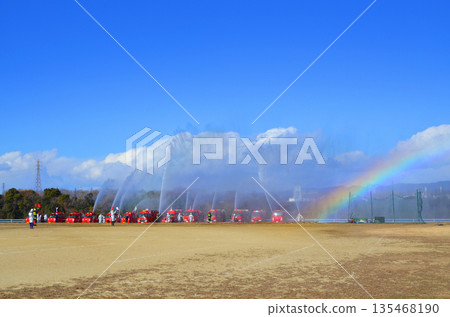 Water spraying demonstration and beautiful rainbow at the New Year's fire brigade ceremony 135468190