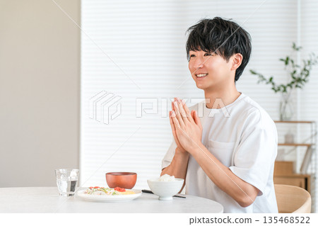 Young Asian man eating at the dining table at home (Itadakimasu) Young Asian man eating at the dining table at home (Itadakimasu) 135468522