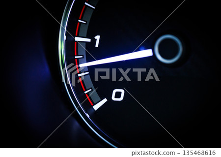 Close-up of a diesel truck's dashboard and tachometer. It represents the power and durability of a work vehicle, with a clear focus on the round engine meters. 135468616