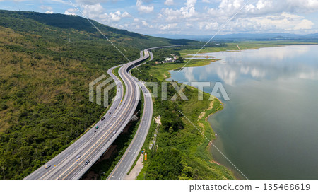 Drone shot The M6 motorway Nakhon Ratchasima Province - Bang Pa-in Lam Ta Khong River and Mountain. Motorway Korat Thailand Drone shot The M6 motorway Nakhon Ratchasima Province - Bang Pa-in Lam Ta Khong River and Mountain. Motorway Korat Thailand 135468619