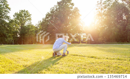 Family bonding. Happy family parenting moment outdoors. 135469714