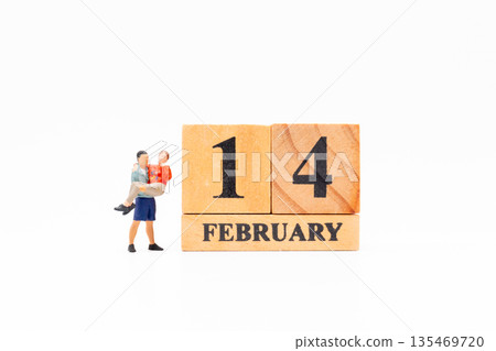 Miniature Couple Beside February 14 Valentine Day Blocks 135469720
