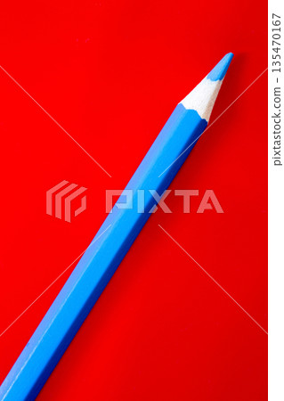 Blue pencil on a red background Blue pencil on a red background 135470167