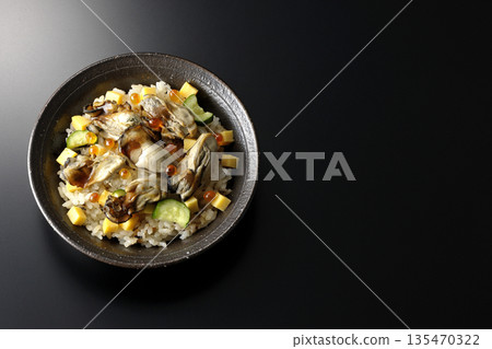 Oyster chirashi sushi photographed against a black background Oyster chirashi sushi photographed against a black background 135470322