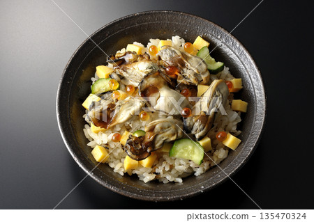 Oyster chirashi sushi photographed against a black background 135470324