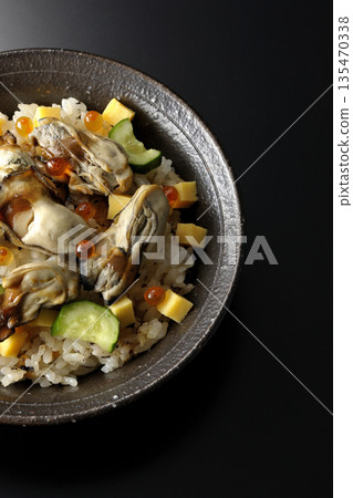 Oyster chirashi sushi photographed against a black background 135470338