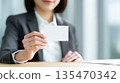 Businesswoman holding a card 01 135470342