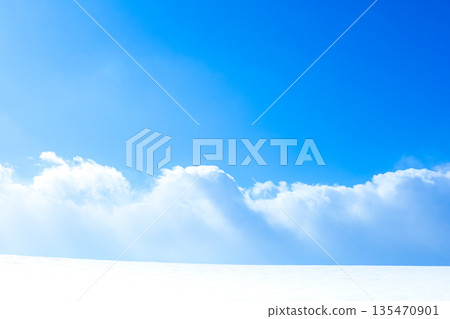 A simple landscape of blue sky, clouds and snowy fields 135470901