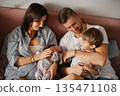 Happy Parents With Newborn And Toddler At Home 135471108
