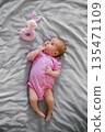 Newborn Baby In Pink Onesie With Plush Bunny Rattle 135471109