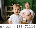 Happy Young Boy With Father And Baby At Home 135471114