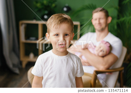 Happy Young Boy With Father And Baby At Home Happy Young Boy With Father And Baby At Home 135471114